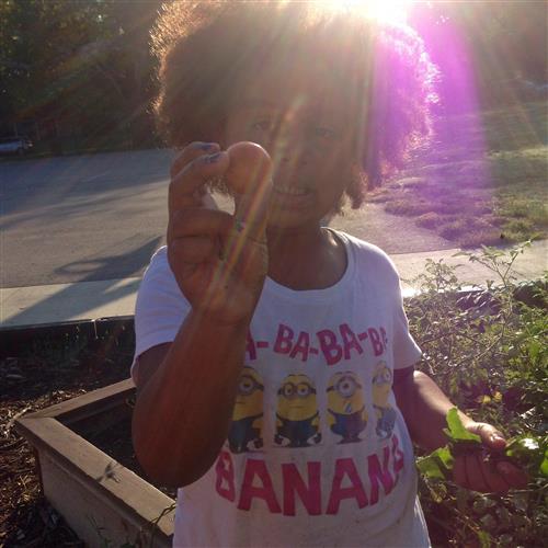 A New York Elementary student shows off her harvest. 
